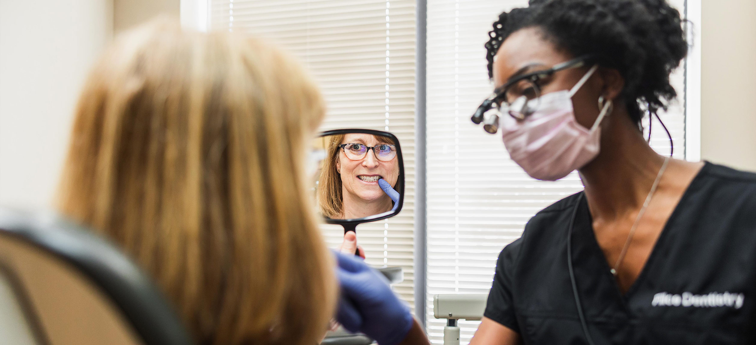 Examining smile in mirror