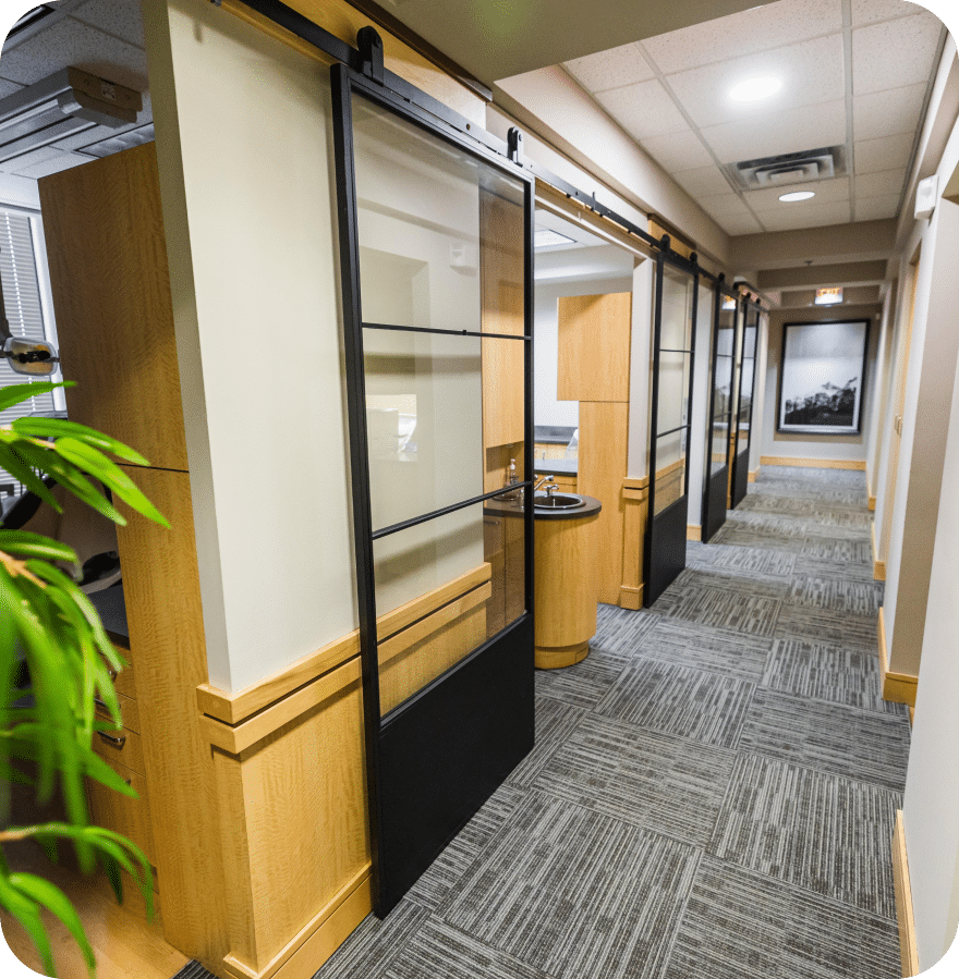 A hallway featuring sliding doors adorned with various indoor plants, creating a serene and inviting atmosphere.