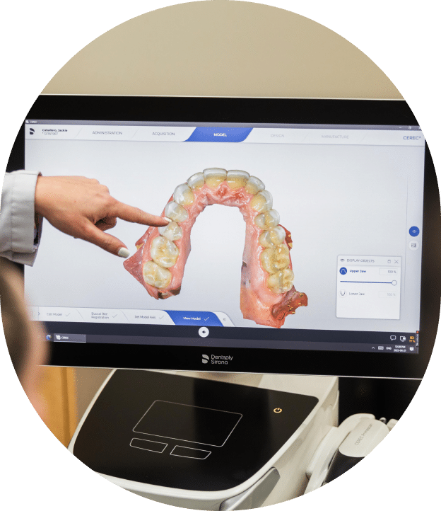 A person demonstrates a dental model on a computer screen, highlighting dental education and technology integration.