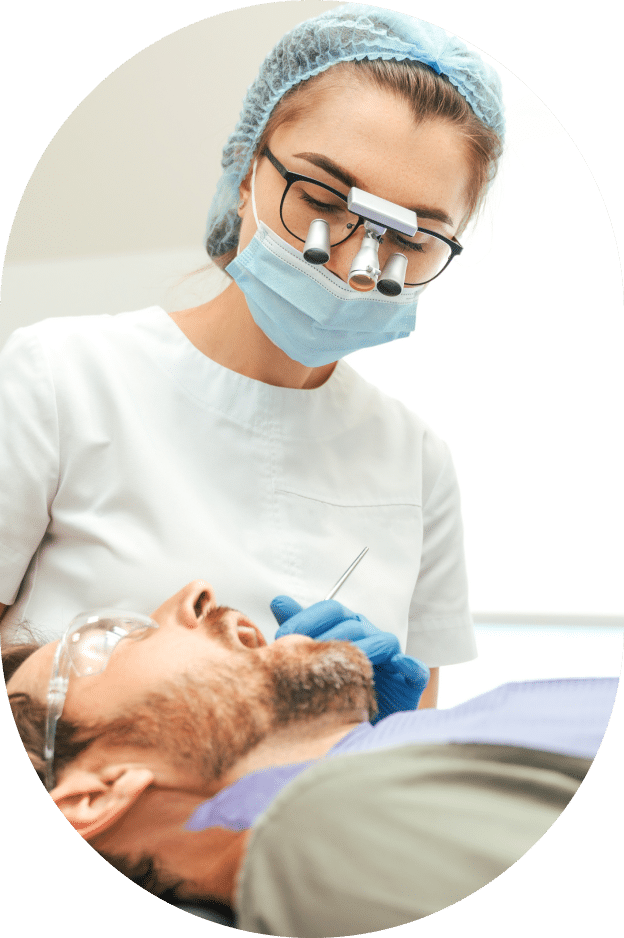 A woman receiving a dental cleaning from a dentist in a clinical setting, showcasing oral hygiene practices.