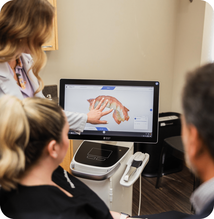 A woman demonstrates a scan on a computer to a patient, highlighting key details for better understanding.