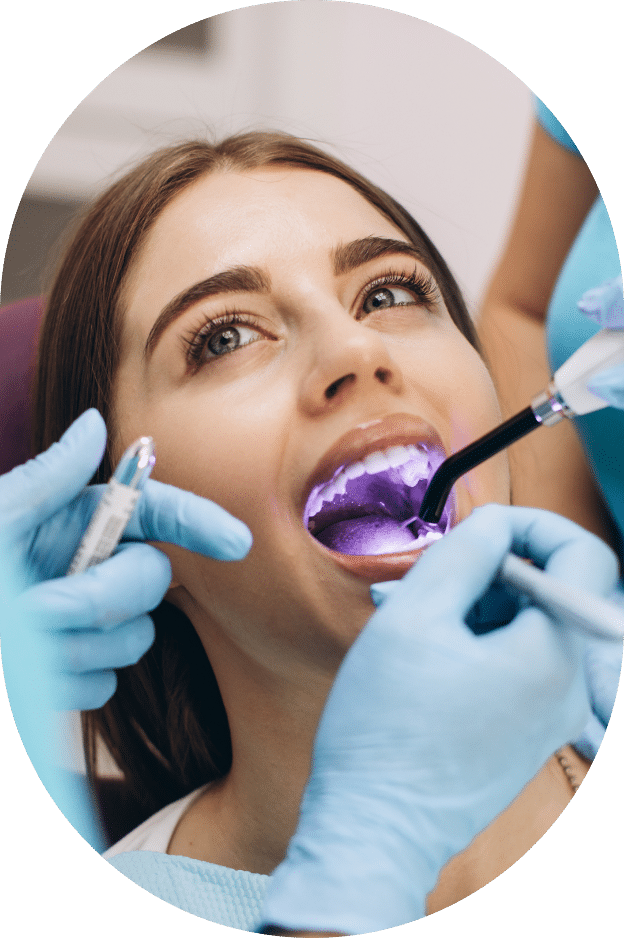 A woman receiving a dental cleaning at the dentist's office, focused on oral hygiene and care.