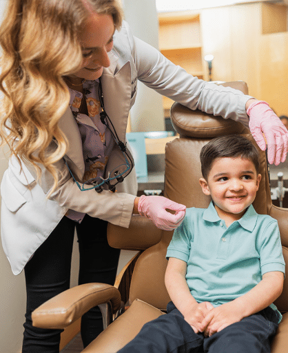 A woman is assessing a young boy seated in a dental chair during a dental examination